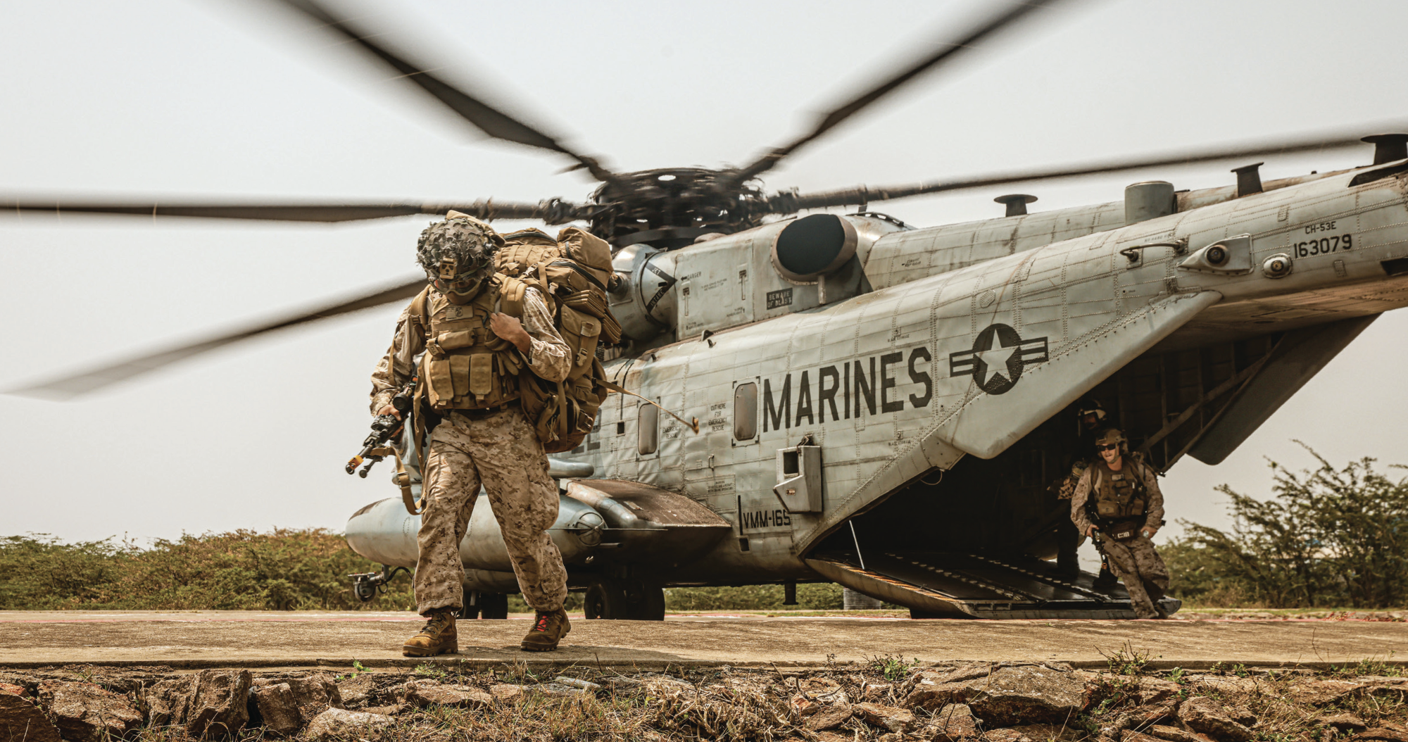 Marines assigned to Charlie Company, Battalion Landing Team 1/5, 15th Marine Expeditionary Unit, exit CH-53E Super Stallion attached toMarine Medium Tiltrotor Squadron 165 (Reinforced), 15th MEU, for amphibious landing during exercise Tiger Triumph at Kakinada Beach, India,March 27, 2024 (U.S. Marine Corps/Aidan Hekker)